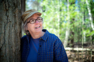 Woman in hat and glasses admires the woods
